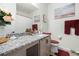 Well-lit bathroom features granite countertops and colorful decorative accents at 37587 Mackenzie Dr, Zephyrhills, FL 33540
