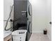 Laundry room features stacked washer and dryer with tile floors and decor at 37587 Mackenzie Dr, Zephyrhills, FL 33540