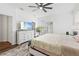 Spacious primary bedroom with hardwood floors, a large mirror, and modern furniture at 37587 Mackenzie Dr, Zephyrhills, FL 33540