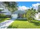 Well-maintained single-story home featuring a bright yellow front door and lush green lawn at 3907 Lake Shore Dr, Palm Harbor, FL 34684