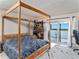A bedroom featuring a four-poster bed and balcony access at 4141 Bayshore Blvd # 1204, Tampa, FL 33611
