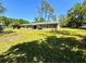 Rear view of the home featuring sliding glass doors and a spacious backyard at 4310 Lithia Pinecrest Rd, Valrico, FL 33596