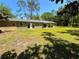 Expansive backyard features lush green grass and an arched doorway on the home's exterior at 4310 Lithia Pinecrest Rd, Valrico, FL 33596
