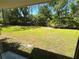 View of the expansive backyard, enclosed by a wood fence and bordered by lush trees, providing privacy at 4310 Lithia Pinecrest Rd, Valrico, FL 33596