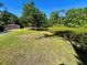 Spacious backyard featuring a shed, wooden deck, and ample green space for recreation and relaxation at 4310 Lithia Pinecrest Rd, Valrico, FL 33596