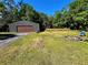 Backyard featuring a shed, fire pit, and comfortable seating, perfect for outdoor gatherings at 4310 Lithia Pinecrest Rd, Valrico, FL 33596