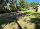 Large backyard featuring a storage shed, wood fence, lush trees and a large grassy area at 4310 Lithia Pinecrest Rd, Valrico, FL 33596