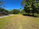 Lush backyard features a green lawn, mature trees, and a shed, ideal for outdoor activities at 4310 Lithia Pinecrest Rd, Valrico, FL 33596