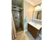Updated bathroom with stone-tiled shower, modern vanity, and neutral color palette at 4310 Lithia Pinecrest Rd, Valrico, FL 33596