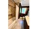 Well-lit bathroom with a tub shower, dark walls, and a dark wood vanity at 4310 Lithia Pinecrest Rd, Valrico, FL 33596