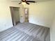Bedroom with plush carpeting, large window, and a spacious closet at 4310 Lithia Pinecrest Rd, Valrico, FL 33596