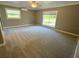 Large bedroom with plush carpet and bright, natural light at 4310 Lithia Pinecrest Rd, Valrico, FL 33596