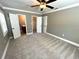 Bedroom with ceiling fan, crown moulding, plush carpeting, and multiple entryways at 4310 Lithia Pinecrest Rd, Valrico, FL 33596