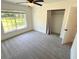Bright bedroom with plush carpeting, large window, and a spacious closet at 4310 Lithia Pinecrest Rd, Valrico, FL 33596
