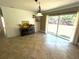 Dining room with slider, shiplap accent wall and neutral ceramic tile at 4310 Lithia Pinecrest Rd, Valrico, FL 33596