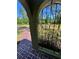 Elegant wrought iron gate entry with brick pavers offers a peek into the lush front yard at 4310 Lithia Pinecrest Rd, Valrico, FL 33596