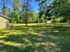 The property boasts a large front yard with mature trees and a view of the quiet street at 4310 Lithia Pinecrest Rd, Valrico, FL 33596