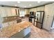 Bright kitchen featuring granite countertops, stainless steel appliances, and white cabinetry at 4310 Lithia Pinecrest Rd, Valrico, FL 33596