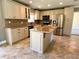 Modern kitchen featuring stainless steel appliances, granite countertops, and an island with seating at 4310 Lithia Pinecrest Rd, Valrico, FL 33596