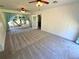 Living room with light-colored walls, plush carpeting, and abundant natural light through large windows at 4310 Lithia Pinecrest Rd, Valrico, FL 33596