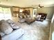 Spacious living room with tile flooring, comfortable seating, and an open view of the modern kitchen at 4310 Lithia Pinecrest Rd, Valrico, FL 33596