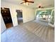 Living room with view of laundry room, light-colored walls, plush carpeting, and abundant natural light at 4310 Lithia Pinecrest Rd, Valrico, FL 33596