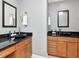Contemporary bathroom featuring dual vanities with black countertops and modern fixtures at 450 Knights Run Ave # 414, Tampa, FL 33602