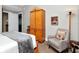 Stylish bedroom with a large wardrobe, comfortable chair, and serene decor at 450 Knights Run Ave # 414, Tampa, FL 33602