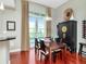 Dining area features wood table, black chairs, and a balcony in an open concept setting at 450 Knights Run Ave # 414, Tampa, FL 33602