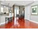 Open-concept kitchen and dining area with wood floors, breakfast bar, and outdoor balcony at 450 Knights Run Ave # 414, Tampa, FL 33602