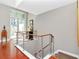 Bright entryway with hardwood floors, modern railings, and a glimpse of the outdoor patio at 450 Knights Run Ave # 414, Tampa, FL 33602