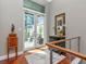 Stylish entryway featuring hardwood floors, modern railings, and access to a private patio with city views at 450 Knights Run Ave # 414, Tampa, FL 33602