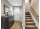 Inviting hallway with a dark dresser and carpeted stairs leading to the upper level at 450 Knights Run Ave # 414, Tampa, FL 33602