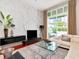 Contemporary living room with sleek furniture, a modern entertainment center, and a view of the lush outdoor patio at 450 Knights Run Ave # 414, Tampa, FL 33602