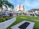 Lounge area with well-manicured lawn and outdoor seating with a fire pit at 450 Knights Run Ave # 414, Tampa, FL 33602