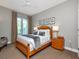 Serene main bedroom featuring a cozy bed and balcony access through stylish curtains at 450 Knights Run Ave # 414, Tampa, FL 33602