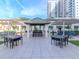 Outdoor kitchen and seating on a paved patio with overhead coverings at 450 Knights Run Ave # 414, Tampa, FL 33602