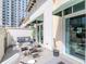 Relaxing patio with dining set, lounge seating, and city views at 450 Knights Run Ave # 414, Tampa, FL 33602