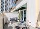 Inviting patio with stylish outdoor furniture and décor, perfect for relaxing or entertaining guests with the city buildings in the background at 450 Knights Run Ave # 414, Tampa, FL 33602