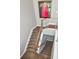 Carpeted staircase with wood and metal railing leading to multiple levels in the home at 450 Knights Run Ave # 414, Tampa, FL 33602