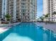 Resort-style swimming pool with lounge chairs and views of a modern condominium complex at 450 Knights Run Ave # 414, Tampa, FL 33602
