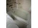 Bathroom showing the bathtub with safety bars and tile flooring at 4715 Bay Ne St # 235, St Petersburg, FL 33703