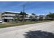 A well maintained three story condominium building with lush landscaping on a beautiful, sunny day at 4715 Bay Ne St # 235, St Petersburg, FL 33703