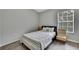 Cozy bedroom with a twin bed, window with blinds, and gray walls at 4921 Barnstead Dr, Riverview, FL 33578