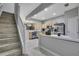 Bright kitchen with stainless steel appliances, seamlessly connected to the living area, and open staircase at 4921 Barnstead Dr, Riverview, FL 33578