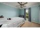 Cozy bedroom with a ceiling fan, window with curtains, and plush carpeting at 502 36Th W St, Palmetto, FL 34221