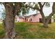 Charming pink single-story home with well-manicured lawn and mature trees in a quiet residential neighborhood at 502 36Th W St, Palmetto, FL 34221