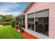 View of the lanai from the backyard showing the dining area and seating at 502 36Th W St, Palmetto, FL 34221