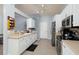 Well-lit kitchen featuring white cabinets, stainless steel appliances, and neutral countertops at 502 36Th W St, Palmetto, FL 34221