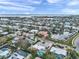 An aerial view showcases waterfront homes with boat docks, backyard pools, and tropical landscaping in a coastal community at 504 69Th St, Holmes Beach, FL 34217